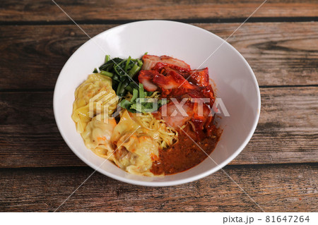 Shrimp dumpling with roasted pork with local thai tom yum spicy sauce on wood background Shrimp dumpling with roasted pork with local thai tom yum spicy sauce on wood background 81647264