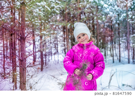 Caucasian girl of 5 years playing in the winter forest, spending time outdoors 81647590