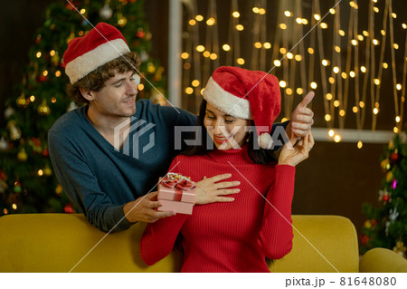 Caucasian woman look surprise with the present from her couple at night during Christmas festival 81648080