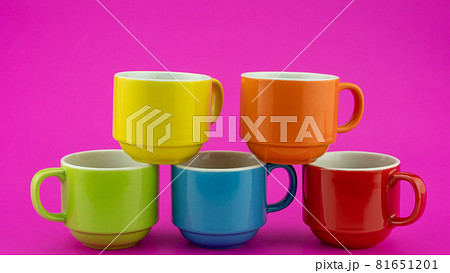 Colorful coffee cup on colorful paper background A lot of cups for coffee and tea in coffee shop Food and drink background concept Colorful coffee cup on colorful paper background A lot of cups for coffee and tea in coffee shop Food and drink background concept 81651201