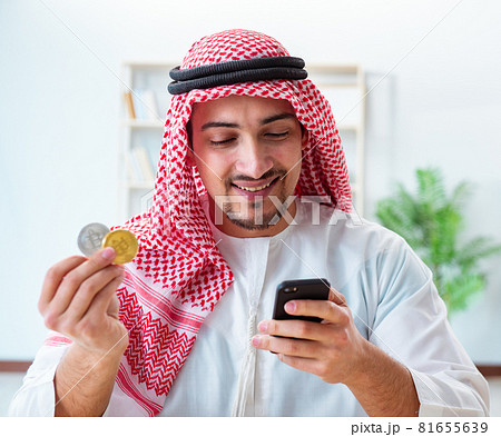 Arab man with bitcoin in cryptocurrency mining concept Arab man with bitcoin in cryptocurrency mining concept 81655639