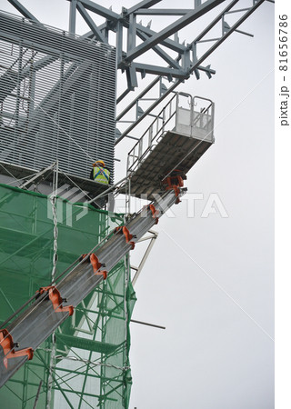 JOHOR, MALAYSIA -MAY 15, 2016: Construction workers standing in the mobile crane bucket while working at high level in the construction site in Malaysia. JOHOR, MALAYSIA -MAY 15, 2016: Construction workers standing in the mobile crane bucket while working at high level in the construction site in Malaysia. 81656786