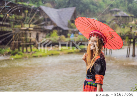 A female tourist dressed in the traditional dress of the inhabitants of the Vietnamese mountains, the Hmong. Woman in Sapa in the fog, Northwest Vietnam. Vietnam travel concept. UNESCO heritage A female tourist dressed in the traditional dress of the inhabitants of the Vietnamese mountains, the Hmong. Woman in Sapa in the fog, Northwest Vietnam. Vietnam travel concept. UNESCO heritage 81657056