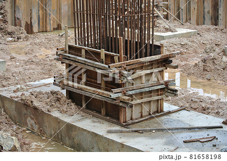 KUALA LUMPUR, MALAYSIA -JUNE 18, 2016: Column timber form work and reinforcement bar at the construction site. Installed by construction workers. The structure supported by temporary wood support. 81658198