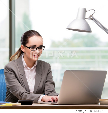 Businesswoman working at her desk Businesswoman working at her desk 81661238