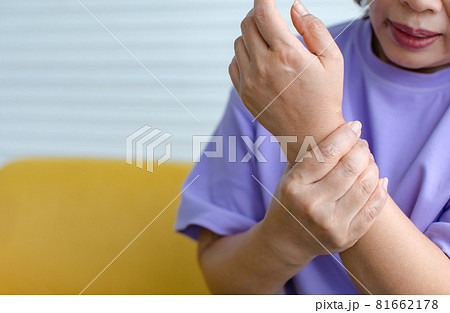 Woman using hand to hold other on arm with and feeling pain, suffer, hurt and tingling. Concept of Guillain barre syndrome and numb hands disease Woman using hand to hold other on arm with and feeling pain, suffer, hurt and tingling. Concept of Guillain barre syndrome and numb hands disease 81662178