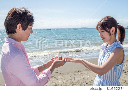 晴れた夏の海辺で指輪を渡すカップル 晴れた夏の海辺で指輪を渡すカップル 81662274