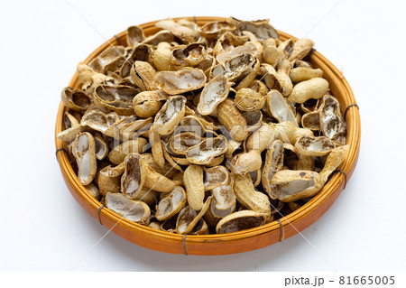 Peanut shells in bamboo basket on white Peanut shells in bamboo basket on white 81665005
