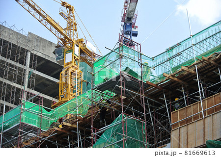 KEDAH, MALAYSIA -AUGUST 05, 2016: Layer of net used to cover the external wall scaffolding. It function is to prevent unwanted object falling outside from the construction site. KEDAH, MALAYSIA -AUGUST 05, 2016: Layer of net used to cover the external wall scaffolding. It function is to prevent unwanted object falling outside from the construction site. 81669613