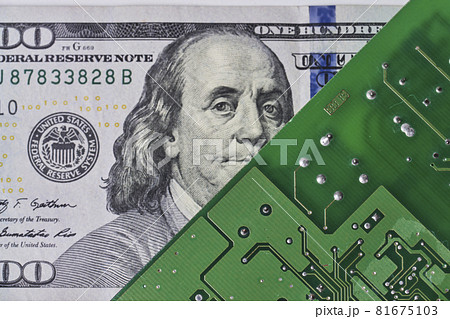 US dollar banknote and printed circuit board. Electronic board and 100 us dollar bill. Dollar bill in front of circuit board. Close-up view of computer board and one hundred dollar money bill 81675103