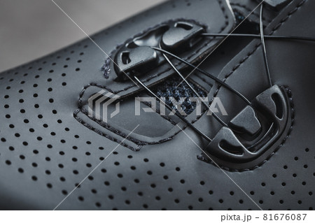 Part of Shoes made of black perforated leather close-up. Part of Shoes made of black perforated leather close-up. 81676087
