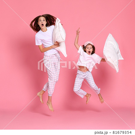 Excited mother and daughter jumping in morning 81679354