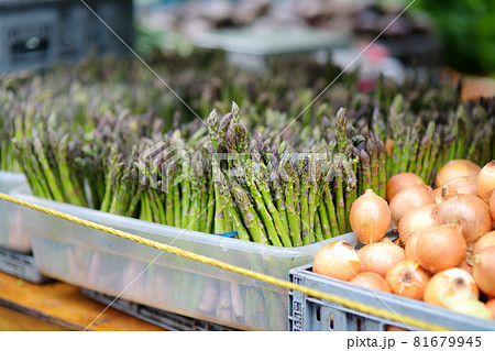 Fresh bio herbs and vegetables on street farmer market. Typical local agricultural fair of weekend. Sale of organic asparagus and onion Fresh bio herbs and vegetables on street farmer market. Typical local agricultural fair of weekend. Sale of organic asparagus and onion 81679945