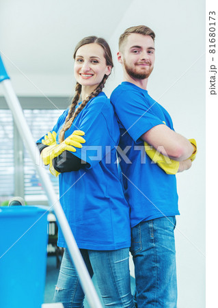 Cleaners being proud of their service standing arms folded 81680173