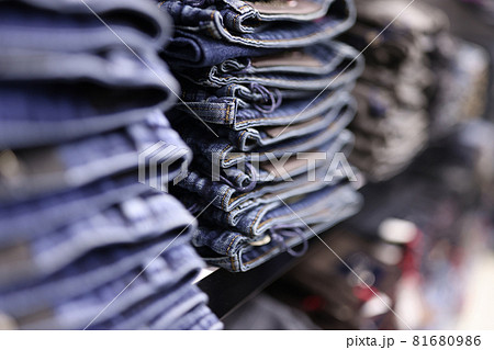 Stack of blue jeans in different shades at store closeup Stack of blue jeans in different shades at store closeup 81680986
