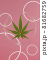 Green hemp leaves on pink background. 3d render texture. Round glass background with glowing circles. 81682759