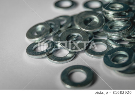 A scattering of metal washers for bolts and screws. 81682920