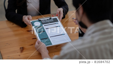 job interview in office, focus on resume writing tips, employer reviewing good cv of prepared skilled applicant, recruiter considering application, hr manager making hiring decision. job interview in office, focus on resume writing tips, employer reviewing good cv of prepared skilled applicant, recruiter considering application, hr manager making hiring decision. 81684702
