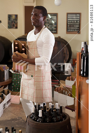 man standing with cardboard box with wine man standing with cardboard box with wine 81686113