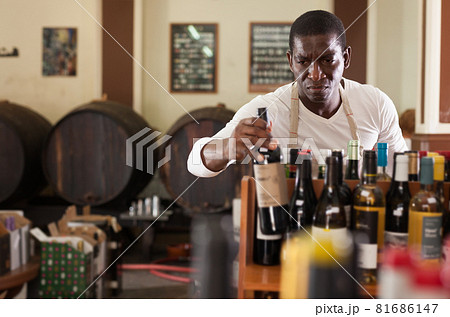 Winemaker arranging bottles in wine shop Winemaker arranging bottles in wine shop 81686147