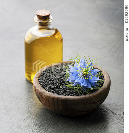 Cumin seed oil with flowers Cumin seed oil with flowers 81692696