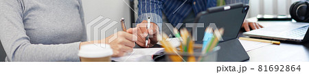 Office work concept two business partners watching a tablet screen and having a conversation on a business topic Office work concept two business partners watching a tablet screen and having a conversation on a business topic 81692864