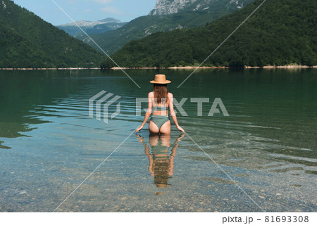 Beautiful woman enjoy mountain Piva lake water in Montenegro 81693308