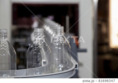 transparent plastic bottle on factory line machine in the beverage manufacturing, selective focus. 81696347
