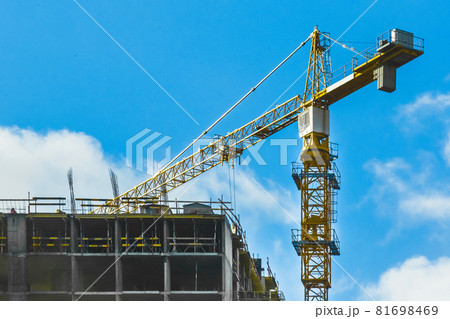 Tower industrial crane on construction site. Building development and work of urban architecture 81698469