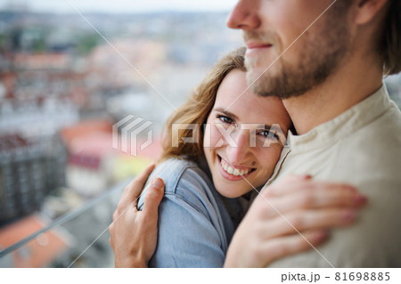 Happy young couple in love standing outdoors on balcony at home, hugging. Happy young couple in love standing outdoors on balcony at home, hugging. 81698885