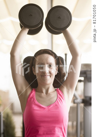Young woman training in the gym happy 81701050