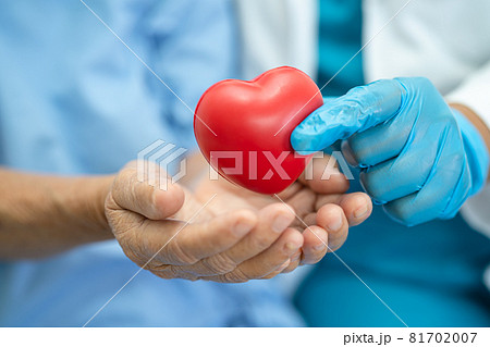 Doctor give red heart to Asian senior or elderly old lady woman patient, healthy strong medical concept Doctor give red heart to Asian senior or elderly old lady woman patient, healthy strong medical concept 81702007