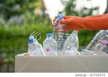 Asian woman volunteer carry water plastic bottles into garbage box trash in park, recycle waste environment ecology concept. Asian woman volunteer carry water plastic bottles into garbage box trash in park, recycle waste environment ecology concept. 81702072
