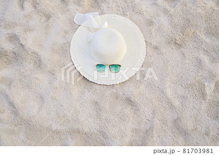 Hats and glasses are located on the sea blue sea beaches on a clear day 81703981