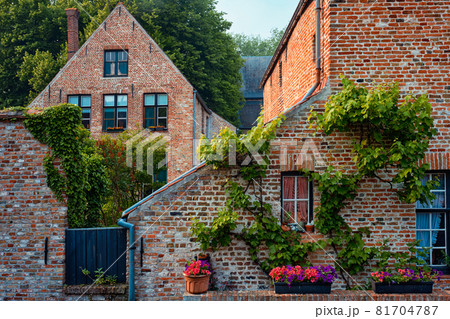 Old housesof Begijnhof Beguinage with flowers in Bruges, Belgium 81704787