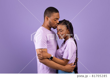 African American man kissing his woman at studio 81705285