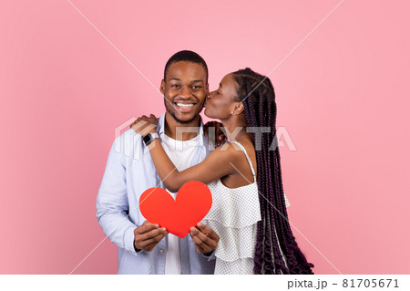 Young Romantic Black Couple Kissing And Holding Red Paper Heart 81705671