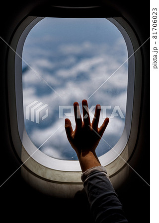 cute toddler points his finger at the sky through the window. first flight concept, traveling with children 81706023