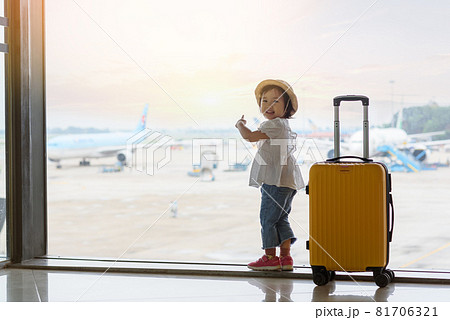 Baby looking at the plane in airport 81706321