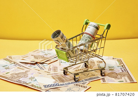 Buying us dollars in Uzbekistan. US dollars roll in shopping trolley and pile of Uzbek sums. Uzbek money and us dollar money exchange Buying us dollars in Uzbekistan. US dollars roll in shopping trolley and pile of Uzbek sums. Uzbek money and us dollar money exchange 81707420