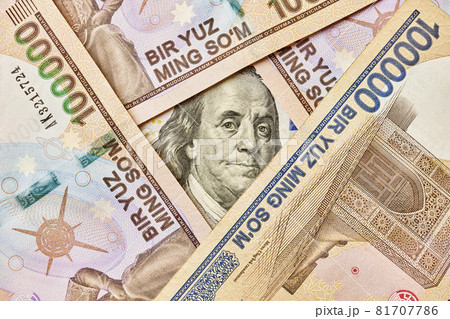 US dollar banknote and Uzbek sums. Concept of exchange rate, Uzbek sum to us dollar. Money exchange in Uzbekistan. Pile of Uzbek money sum and American dollar bill US dollar banknote and Uzbek sums. Concept of exchange rate, Uzbek sum to us dollar. Money exchange in Uzbekistan. Pile of Uzbek money sum and American dollar bill 81707786