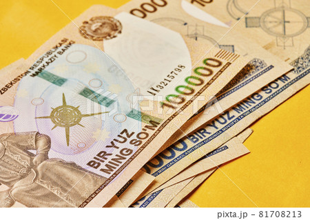 Macro shot of uzbek sum banknote. Pile of Uzbek sums. Uzbek currency money bill. A stack of one hundred thousand Uzbek sum. 100000 sum Macro shot of uzbek sum banknote. Pile of Uzbek sums. Uzbek currency money bill. A stack of one hundred thousand Uzbek sum. 100000 sum 81708213
