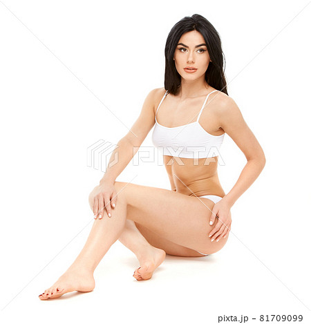 Fitness young woman with a beautiful body sitting on white background 81709099