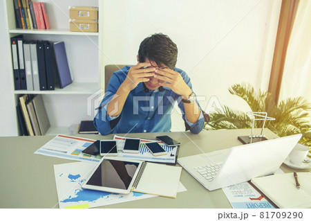 businessman who looks busy negotiating through multiple mobile phones. During the coronavirus disease 2019 epidemic around the world. Working from home businessman who looks busy negotiating through multiple mobile phones. During the coronavirus disease 2019 epidemic around the world. Working from home 81709290