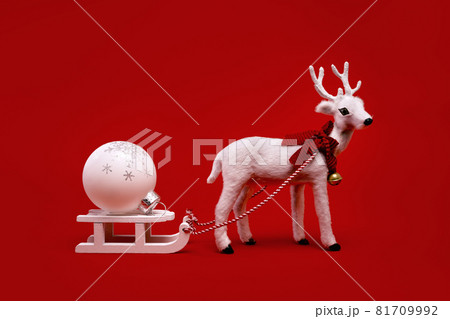 White toy reindeer on Christmas red background White toy reindeer on Christmas red background 81709992