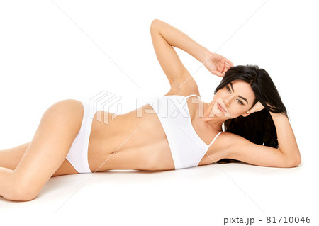 Fitness young woman with a beautiful body sitting on white background Fitness young woman with a beautiful body sitting on white background 81710046