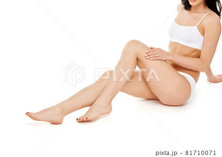 Fitness young woman with a beautiful body sitting on white background Fitness young woman with a beautiful body sitting on white background 81710071