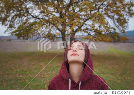 Portrait of a young woman in hoodie in the nature Portrait of a young woman in hoodie in the nature 81710072