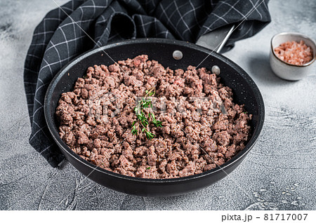 Fried ground mince beef and pork meat in a pan with herbs. White background. Top view Fried ground mince beef and pork meat in a pan with herbs. White background. Top view 81717007