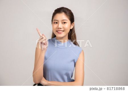 Thinking asian woman stand up  isolated on white background.Asian female model smiling looking up.woman pointing fingers away on white background  isolated. 81718868